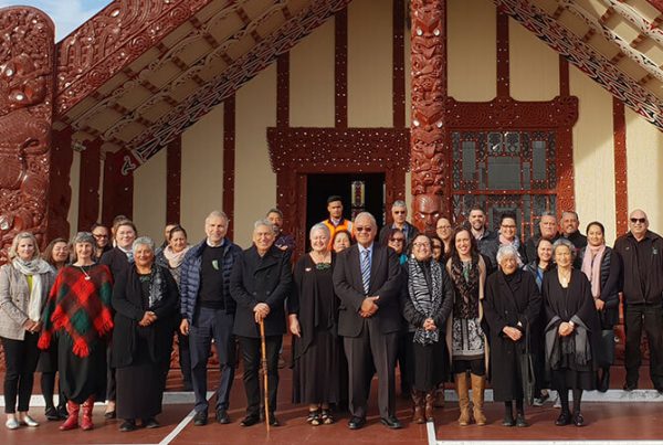 Dr Sam Tsemberis, wearing his new pounamu, with Rotorua community representatives outside Te Papaiouru Marae, Ohinemutu, Rotorua