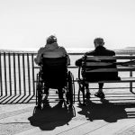 Elderly pair sitting together outside