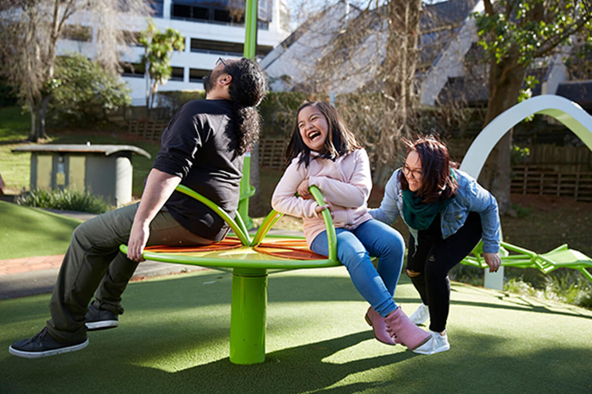 Family playing on a playground