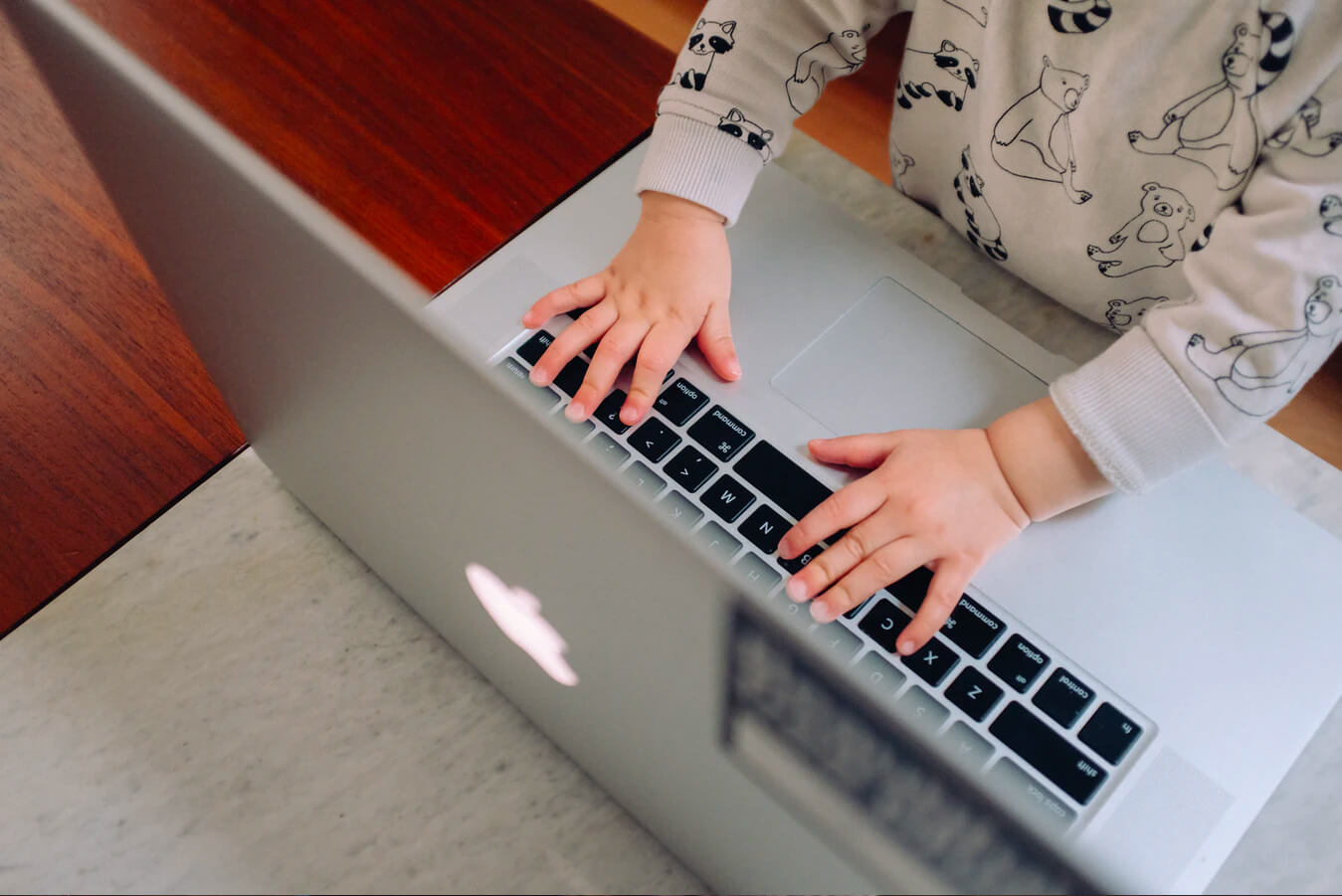A child using an Apple laptop