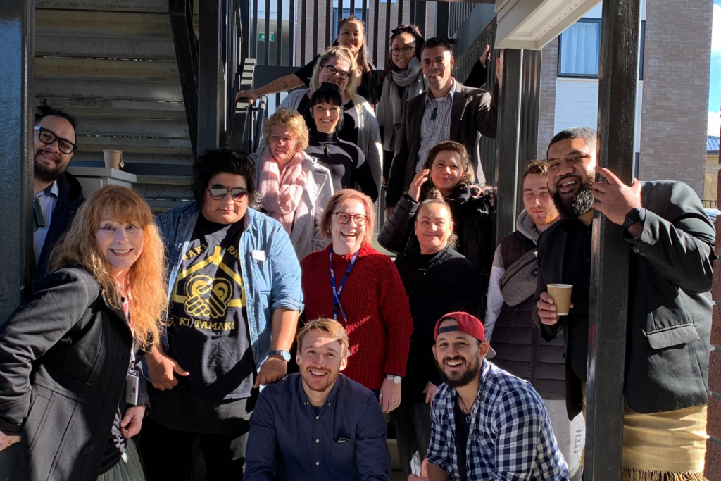 A big group of people from the Lifewise Youth Housing Team with big bright smiles