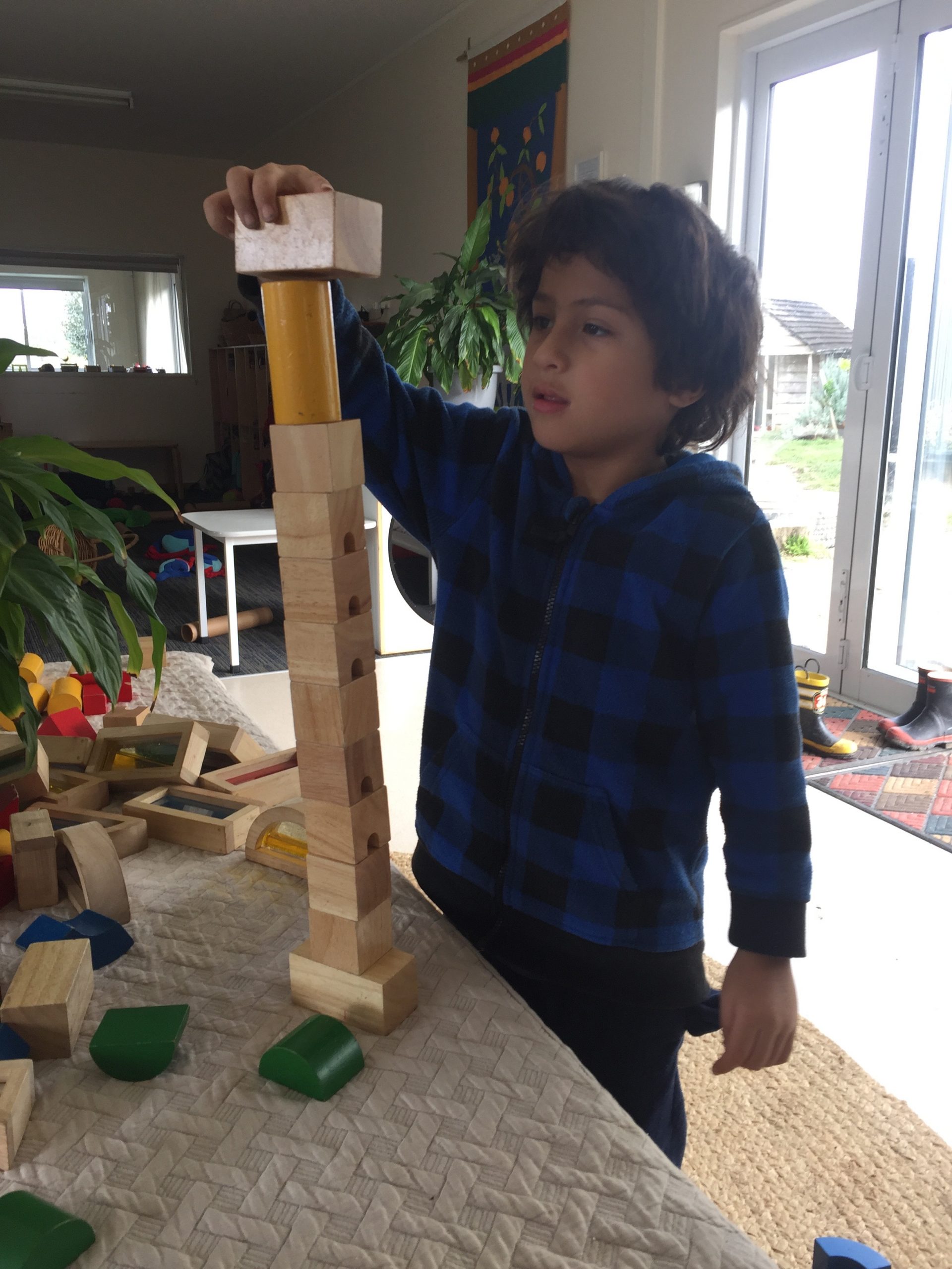 Kane building a tower with blocks by himself at home