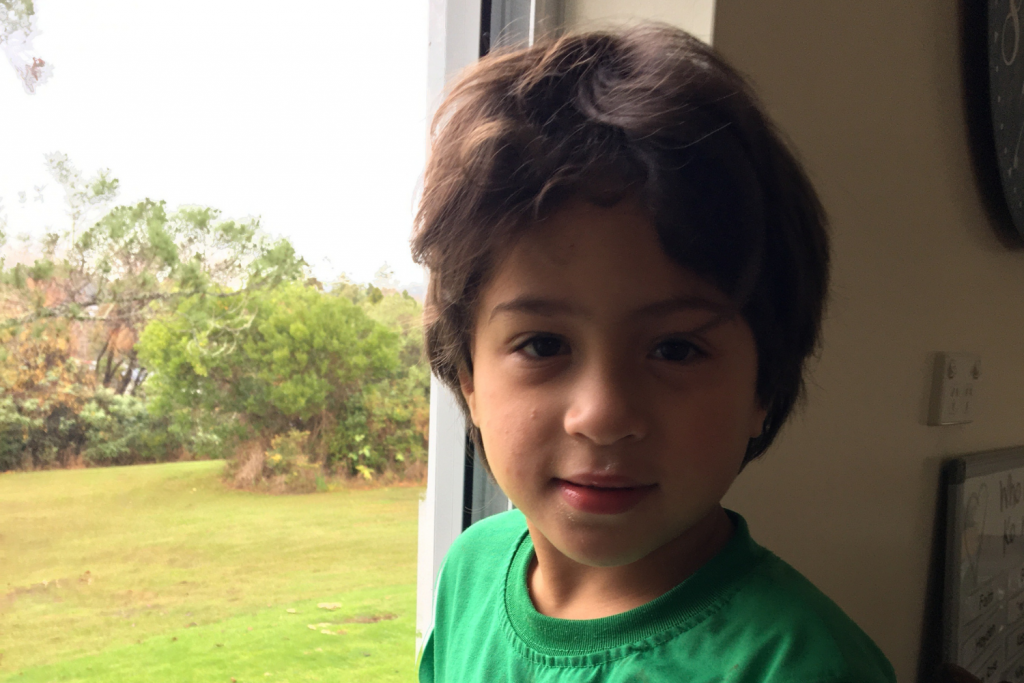 A close up photo of Kane smiling at the camera